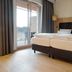 Waldhotel am Notschreipass in Todtnau bedroom with twin beds and balcony doors to a mountain view