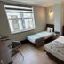 Nif Ankara Hotel room with two single beds, window, and wall sconces in Ankara