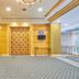 The Royal City Hotel Bangkok lobby with patterned carpet, seating, decorative wall art and gold accents