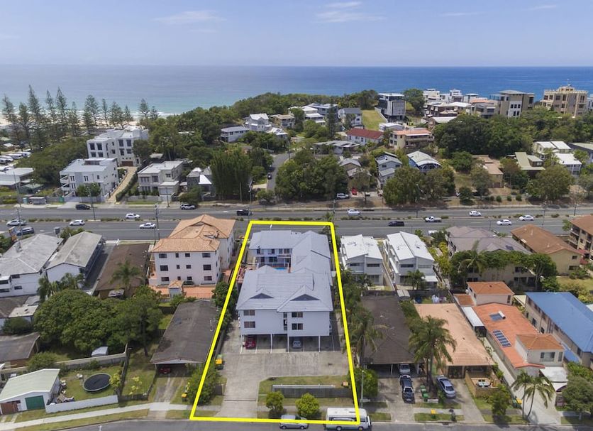 Sunshine Beach Resort in Miami with ocean view and highlighted building near the beach
