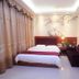 Shanghaojia Hotel in Shaoguan guest room with double bed, sofa, and wall art