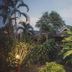 Kalm Pai in Pai surrounded by lush tropical gardens and palm trees at dusk