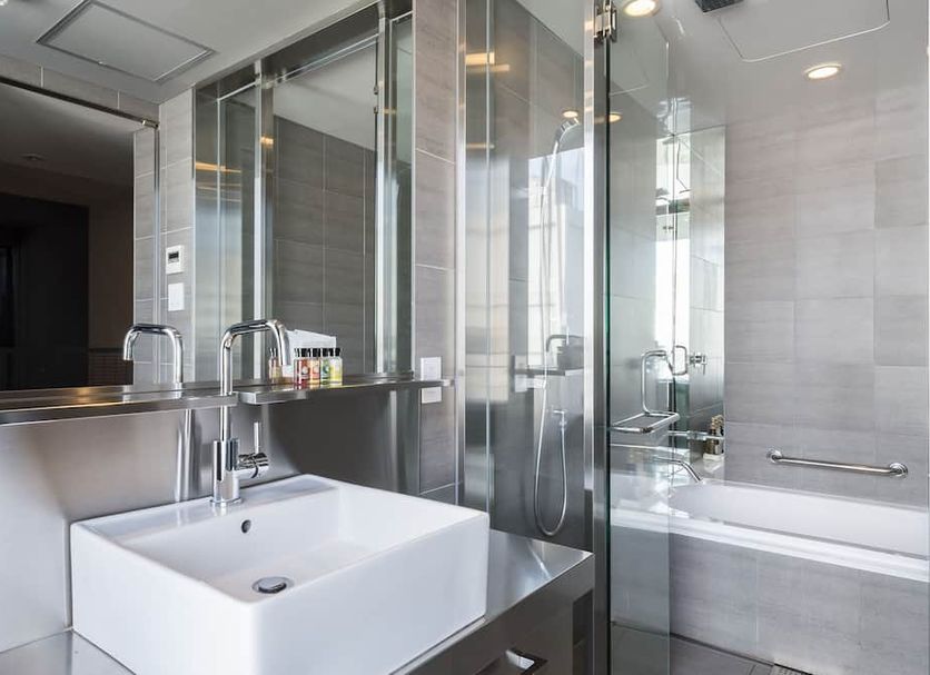 Akasaka Granbell Hotel in Tokyo bathroom with vessel sink, glass shower and bathtub