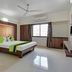 Sai Sangam Hotel, Shirdi guest room with double bed, sofa, ceiling fan and window