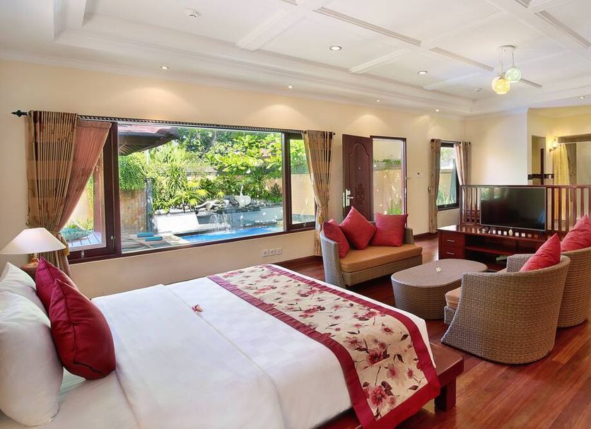 The Grand Bali Nusa Dua in South Kuta guest room with pool view and seating area