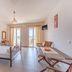 Hotel Aphrodite, Stoupa: bright guest room with iron bed, balcony doors, seating area and TV