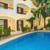Hotel Riviera Caribe Maya in Playa del Carmen with courtyard pool and arched balconies