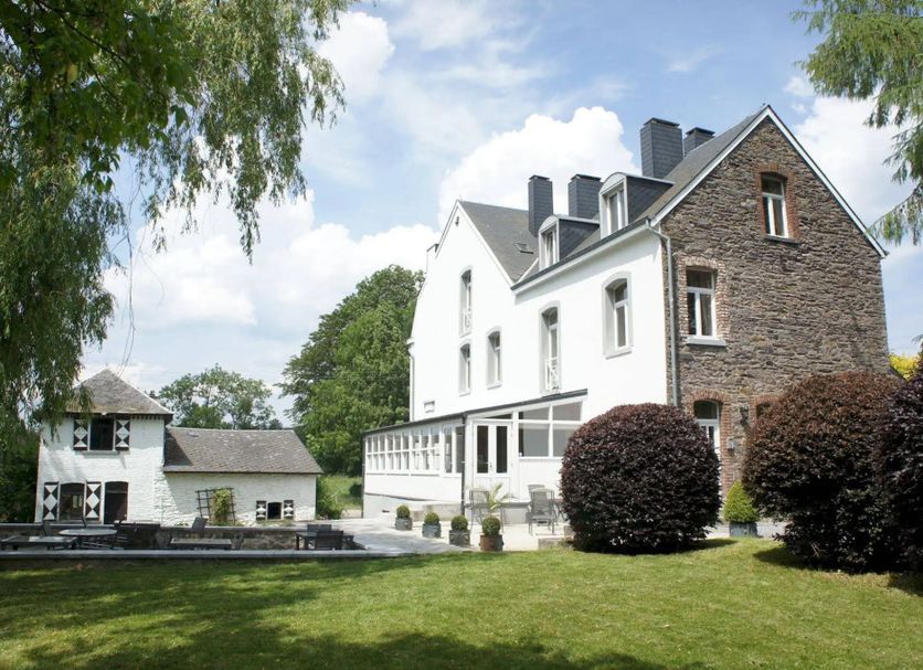 La Maison De Maitre in Arbrefontaine, exterior of white and stone hotel with landscaped lawn