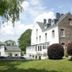 La Maison De Maitre in Arbrefontaine, exterior of white and stone hotel with landscaped lawn