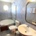Hotel Cabanas Alto Da Serra bathroom with bathtub, sink, toilet, and mirror in Canela