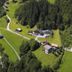 Hotel Montabella in Tschagguns overlooking a lush alpine valley with scattered buildings and forested hills