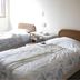 Date Business Hotel Castle in Noboribetsu: twin beds in a simple guest room with a small table