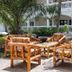 Sarges Hotel in Serrekunda patio seating area with bamboo chairs and tables beside a white building