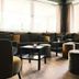 Hotel Sturm Bio- & Wellnesshotel in der Rhön lounge with sofas, low tables and large windows in Mellrichstadt