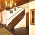 Churfuerstliche Waldschaenke in Moritzburg hallway with wooden staircase, chandelier and patterned runner