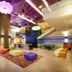 Aloft Panama in Panama City lobby with colorful seating, bar, pool table and cloud-like ceiling lights