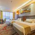 Yichang Guobin Bandao Hotel guest room in Yichang with two beds and city-view windows
