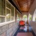 Hotel Troy Nairobi covered balcony corridor with arched openings, wooden ceiling, and outdoor seating