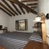 El Horcajo Ronda guest room with wood-beam ceiling, bed, window view and rustic furnishings