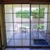 4 Seasons at Desert Breezes in Palm Desert, patio view through sliding glass doors to outdoor seating and garden