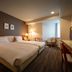 Air Terminal Hotel Chitose guest room with two beds, desk, and window seating