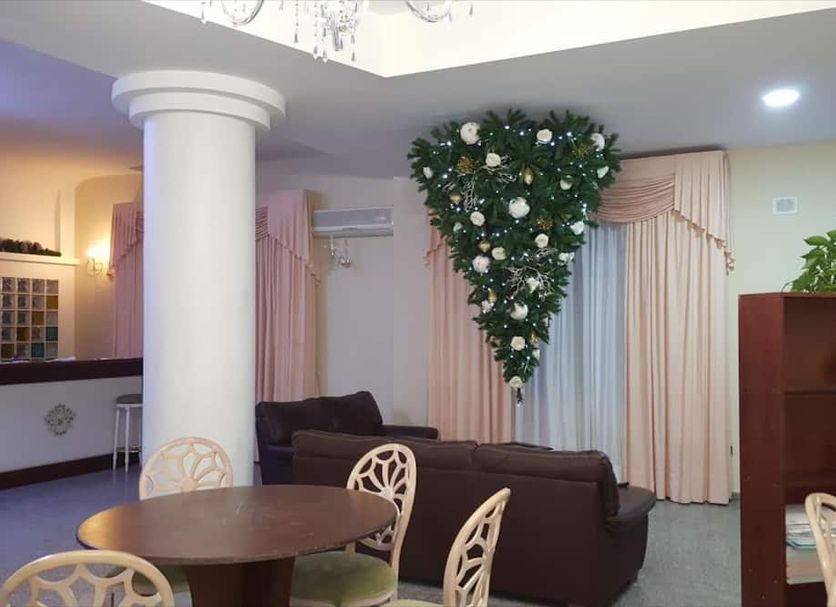 Hotel Miramare in Corigliano Calabro: lounge with round table, sofa, column, and heart-shaped wall greenery