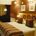 Altos Ushuaia Hotel & Resto room with king bed, desk, seating area and window view in Ushuaia