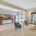 Best Western Wesley Chapel lobby with green seating, coffee tables, and front desk