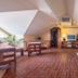 Hotel Vivar attic lounge in Griñón with sloped ceiling, seating area, TV and large windows