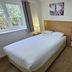 Homefield Lodge in London guest room with double bed, window, and small tea station