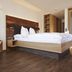 Hotel garni Oberdorfer Stuben room in Fischen im Allgäu with wood bed, bench seating and balcony door