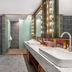 James Joyce Coffetel Hotel Qinhuangdao bathroom with double sinks, bathtub and glass shower