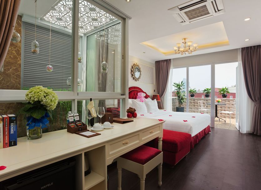 Luxury Old Quarter Hotel & Gym Hanoi room with balcony and city view, vanity desk, and bed