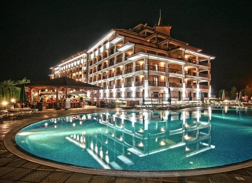 Night view of Casablanca in Obzor with a lit outdoor pool reflecting the hotel facade