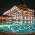 Night view of Casablanca in Obzor with a lit outdoor pool reflecting the hotel facade