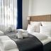 Hotel Bethel Copenhagen guest room with double bed, navy curtains and striped wood headboard