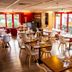 initial by balladins La Roche-sur-Yon dining room with modern tables, chairs and red-framed windows