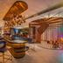 Capri by Fraser, Bukit Bintang in Kuala Lumpur lobby with curved bar, chandelier, and spiral staircase