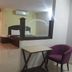 Hotel Meena Paradise in Visakhapatnam room with bed, desk and purple chair