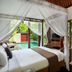 Gending Kedis Luxury Villas & Spa Estate in South Kuta: villa bedroom with canopy bed, pool and balcony views