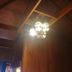 Wood House Pattaya in Pattaya, wood-paneled ceiling with ornate hanging chandelier lighting