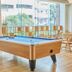The Royal City Hotel in Bangkok game room with pool table and large windows