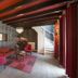 Romantik Hotel Kasteel Daelenbroeck lounge with red chairs, patterned wallpaper, and staircase in Herkenbosch