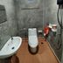 Tonkong Guesthouse & Restaurant bathroom in Chiang Khan with toilet, sink, shower and small window
