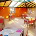 Hotel Adagio Knokke Heist dining room with colorful chairs and skylight
