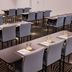 Atura Dandenong meeting room with rows of tables and gray chairs in Dandenong