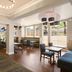 Hampton Inn & Suites Ft. Lauderdale Airport/South Cruise Port lobby with seating and dining tables in Hollywood