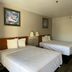 Motel 6 - Laurel, MS guest room with two double beds and framed wall art in Laurel
