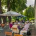 Hotel Knorre in Meissen: riverside terrace with outdoor dining under trees and umbrellas