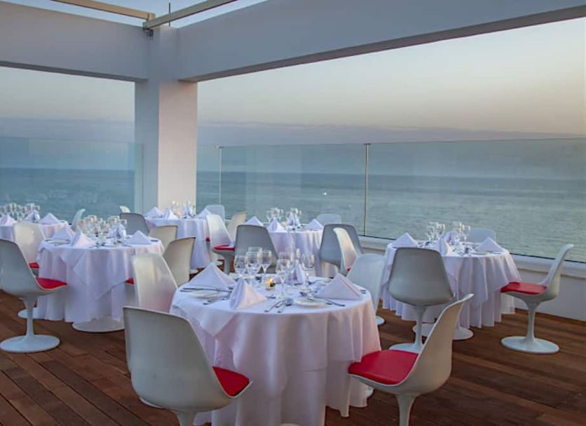 King Evelthon Beach Hotel & Resort in Paphos seaside terrace dining with ocean view at sunset